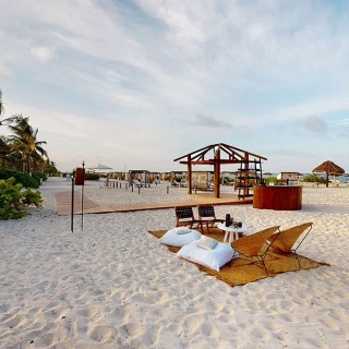 Cocktail setting in beach venue at atelier playa mujeres resort