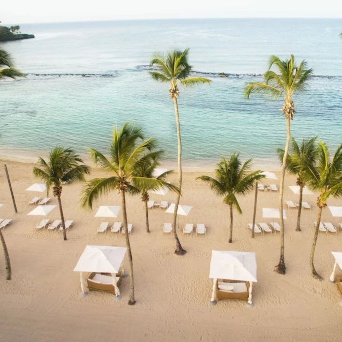 beach at Casa de Campo with loungers, cabanas and swaying palms