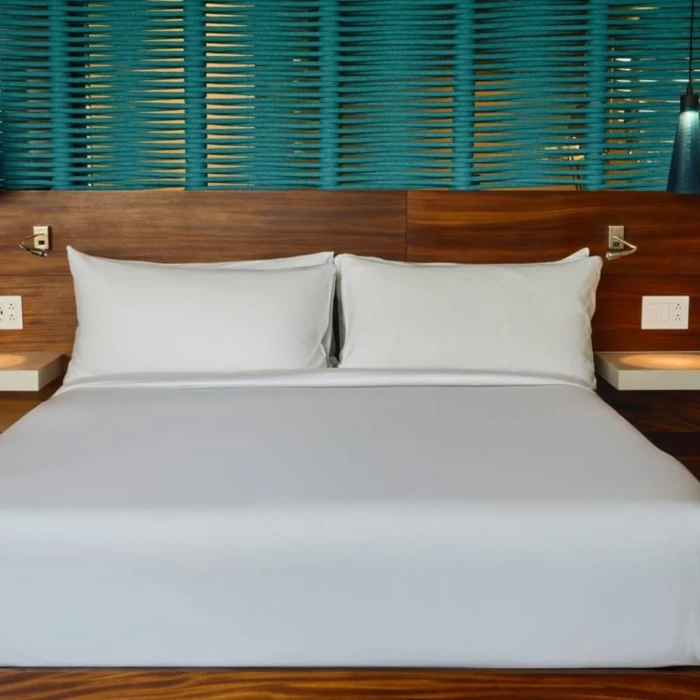 king bed inside suite at Devossion by Live Aqua Playa del Carmen