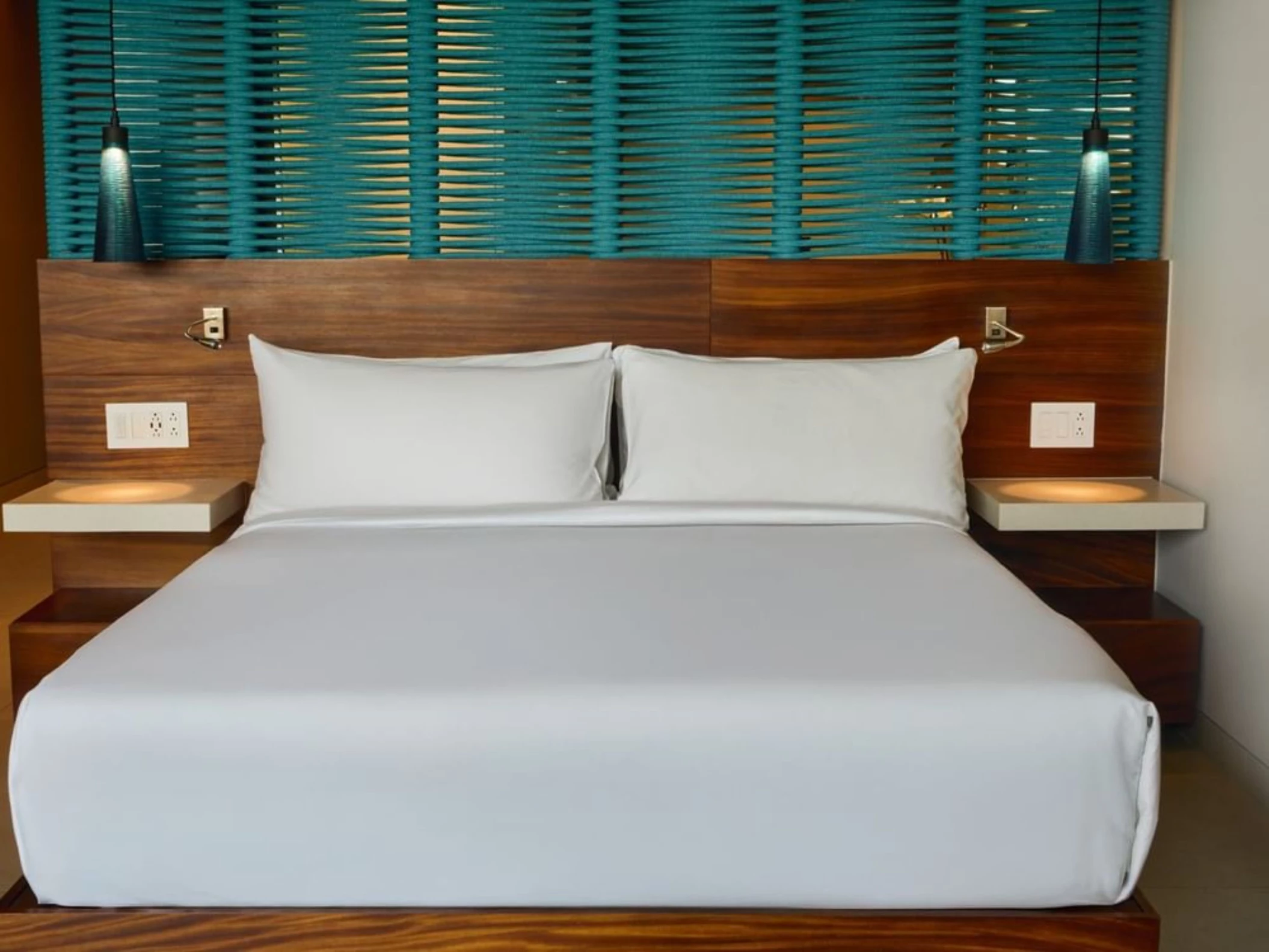 king bed inside suite at Devossion by Live Aqua Playa del Carmen