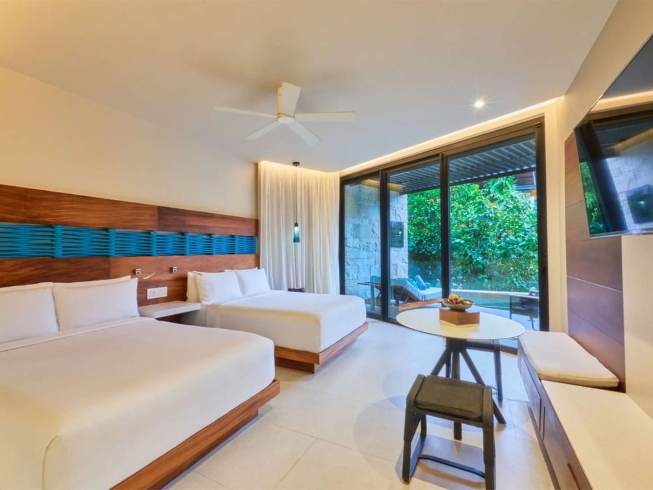 suite with two beds at Devossion by Live Aqua Playa del Carmen