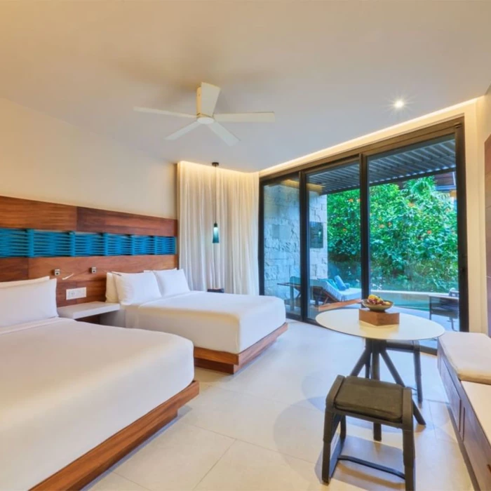 suite with two beds at Devossion by Live Aqua Playa del Carmen
