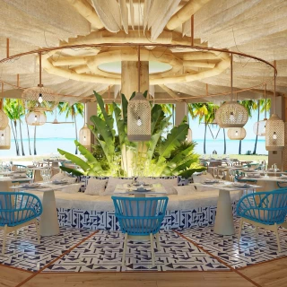 Interior of the Bluewater Grill restaurant, featuring light blue chairs, a circular booth, and ocean views.