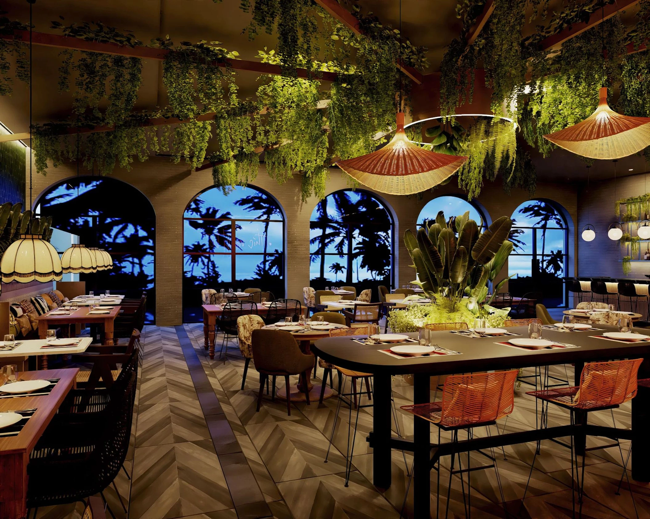 The interior of the Tierra restaurant, decorated with hanging plants, arched windows, and wicker lamps.