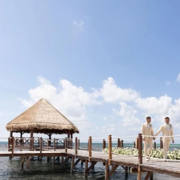 2 grooms at the overwater gazebo venue at Dreams Puerto Morelos Resort & Spa