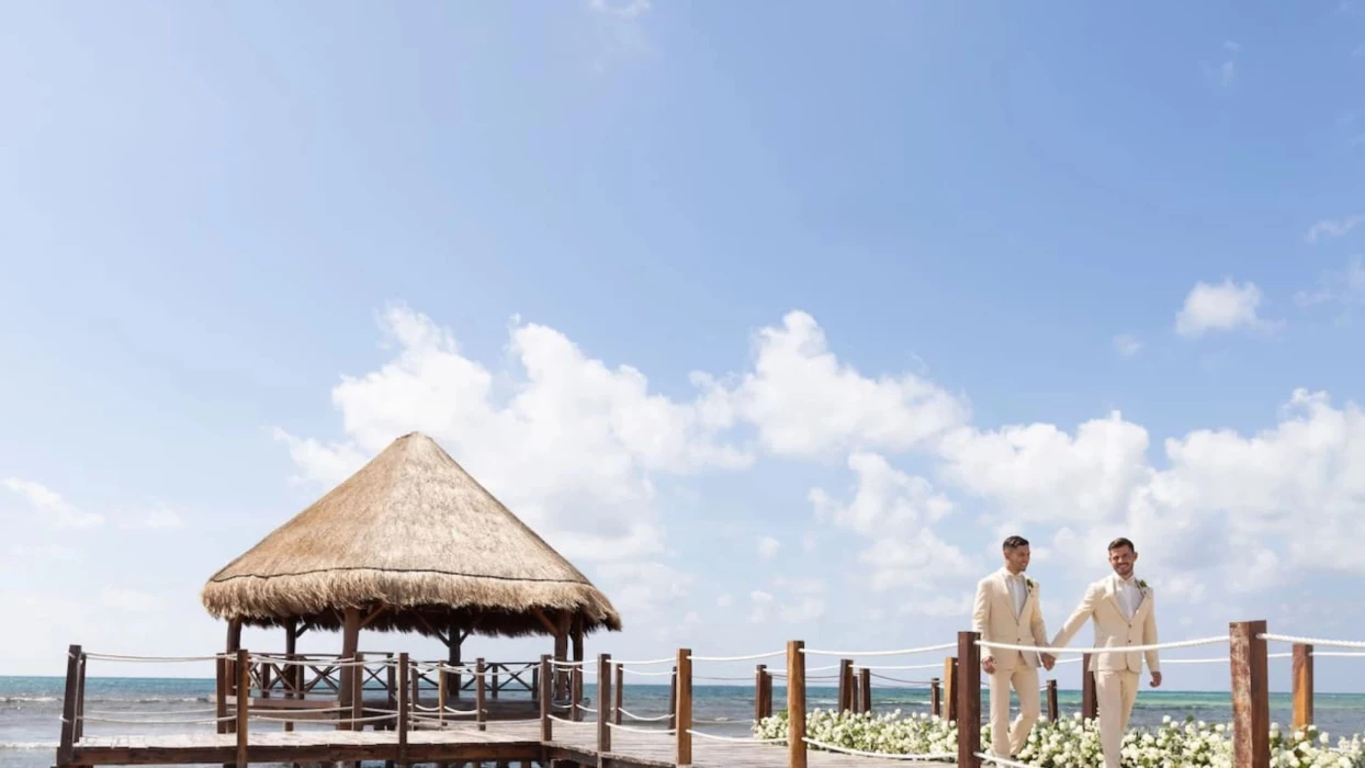 2 grooms at the overwater gazebo venue at Dreams Puerto Morelos Resort & Spa