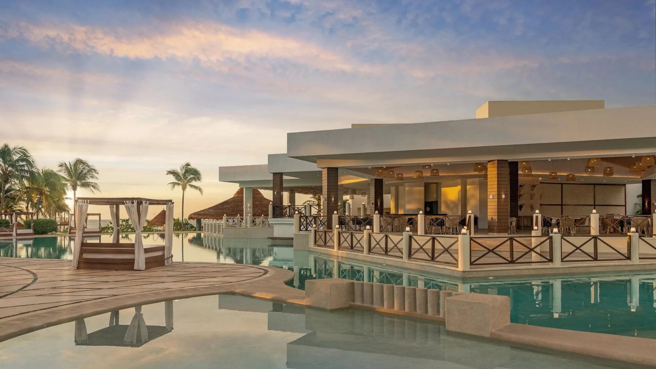 main pool and poolside restaurant at Dreams Puerto Morelos Resort & Spa