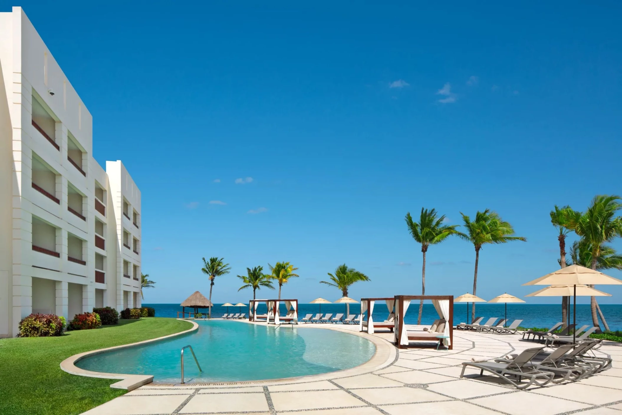 main pool and the resort buildings at Dreams Puerto Morelos Resort & Spa