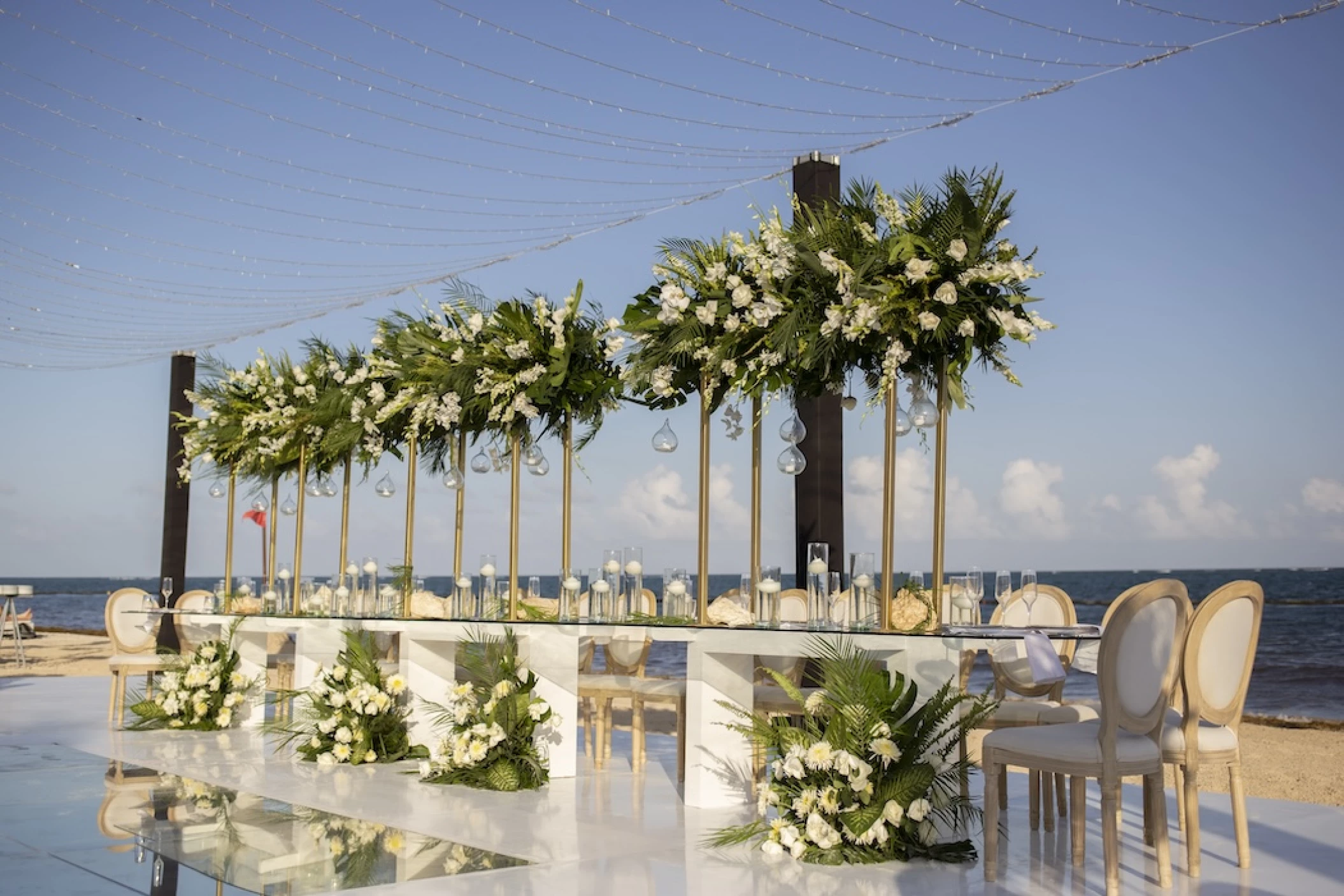 long wedding set-up on beach Secrets Riviera Cancun