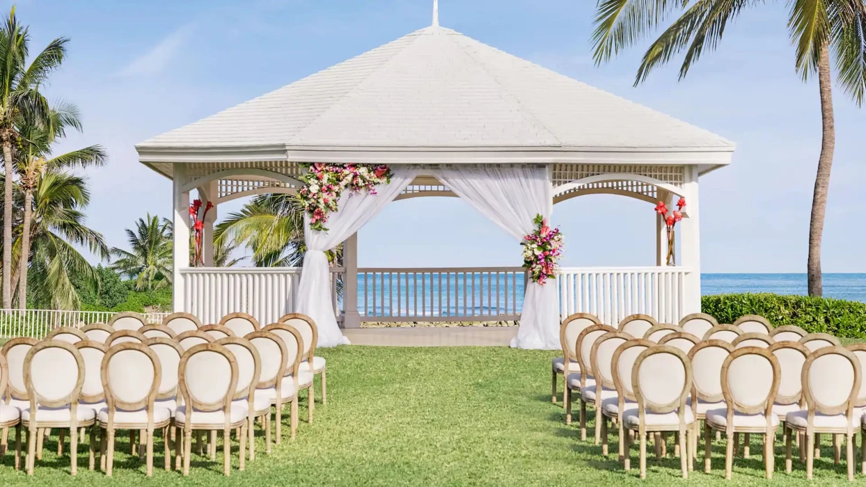 A charming gazebo wedding venue at the resort, decorated with flowers and overlooking the stunning ocean.