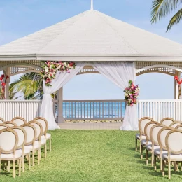 A charming gazebo wedding venue at the resort, decorated with flowers and overlooking the stunning ocean.
