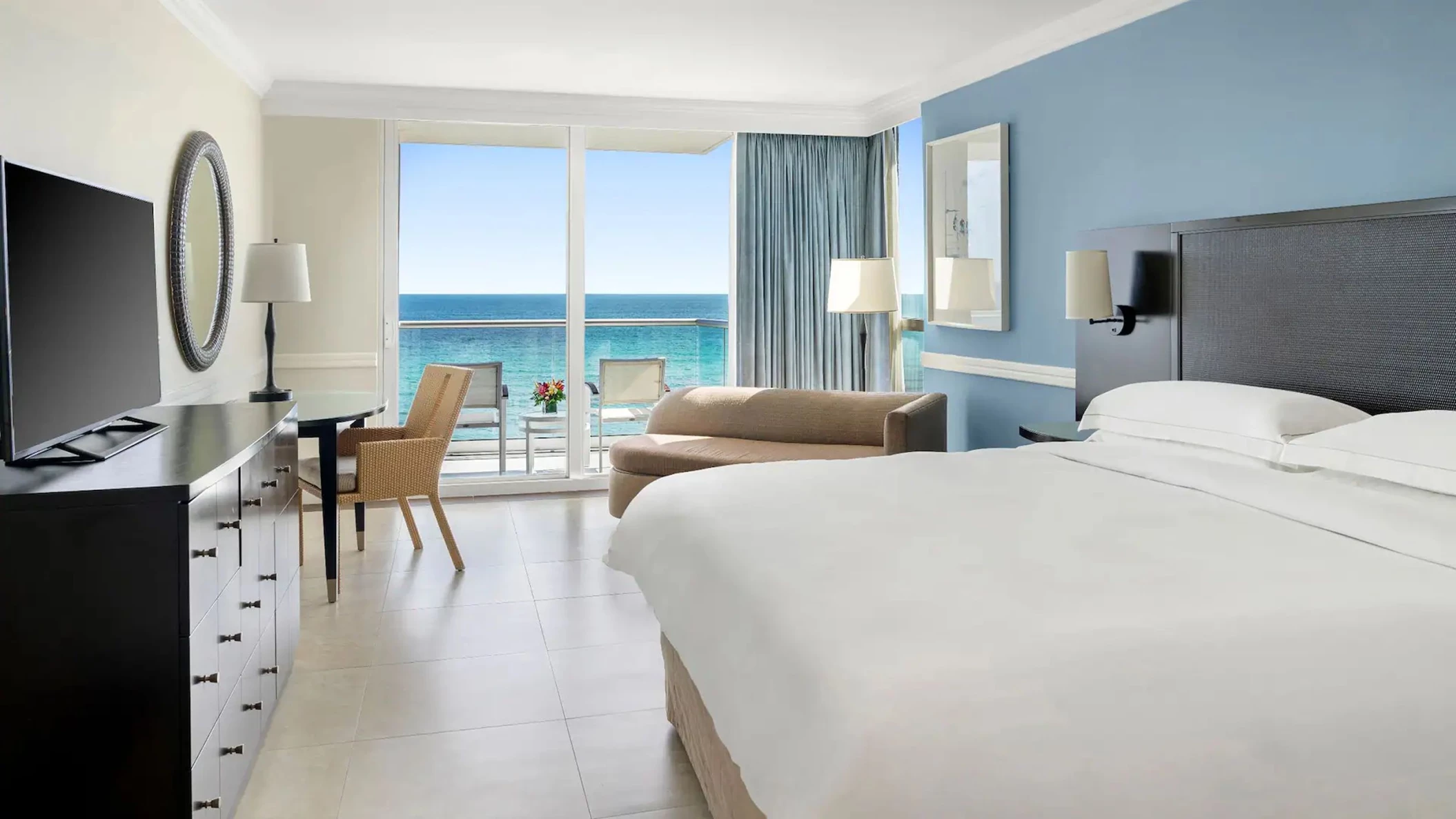 An Oceanfront King room featuring a comfortable king bed and a balcony with a stunning, direct view of the sea.