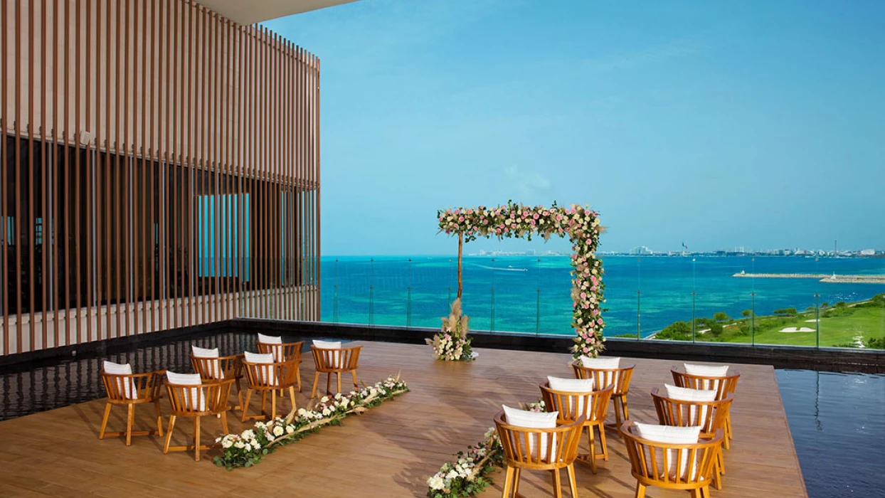 Terrace wedding venue overlooking ocean and golf at Dreams Vista Cancun Golf and Spa