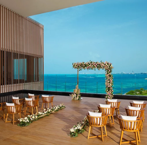 Terrace wedding venue overlooking ocean and golf at Dreams Vista Cancun Golf and Spa