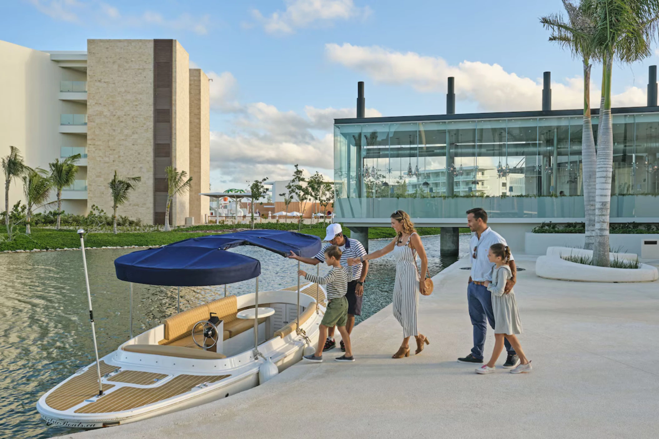 family stepping on a boat at Grand Palladium Select Costa Mujeres
