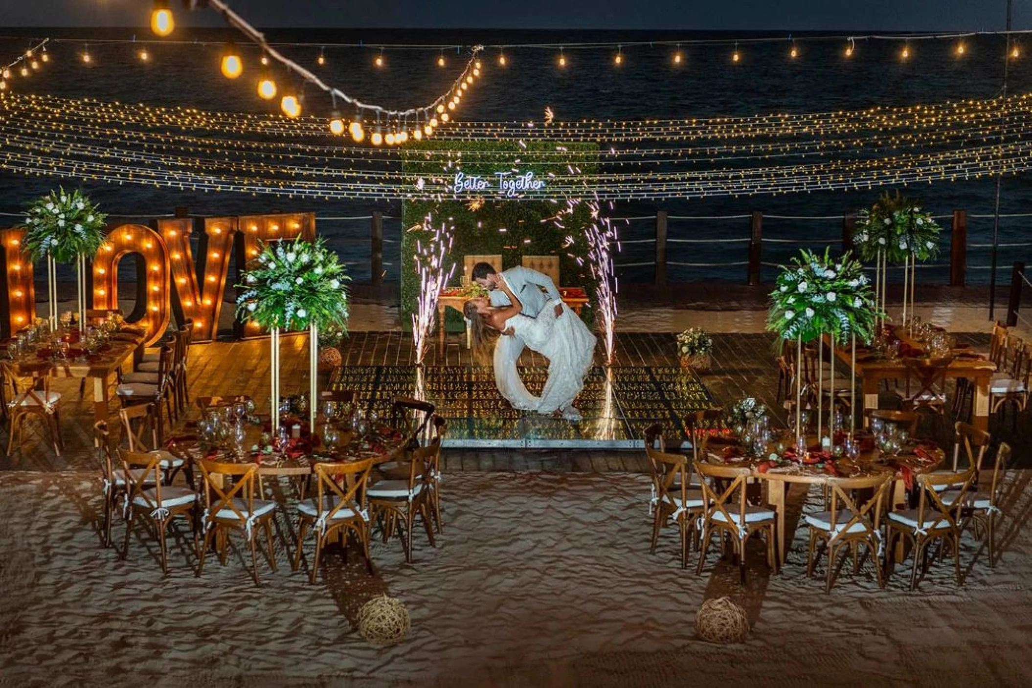 bride and groom at their reception on the beach at Ocean Maya Royale