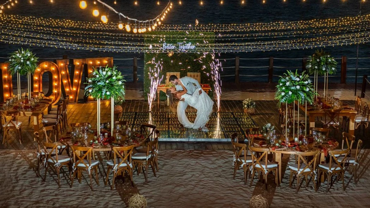 bride and groom at their reception on the beach at Ocean Maya Royale