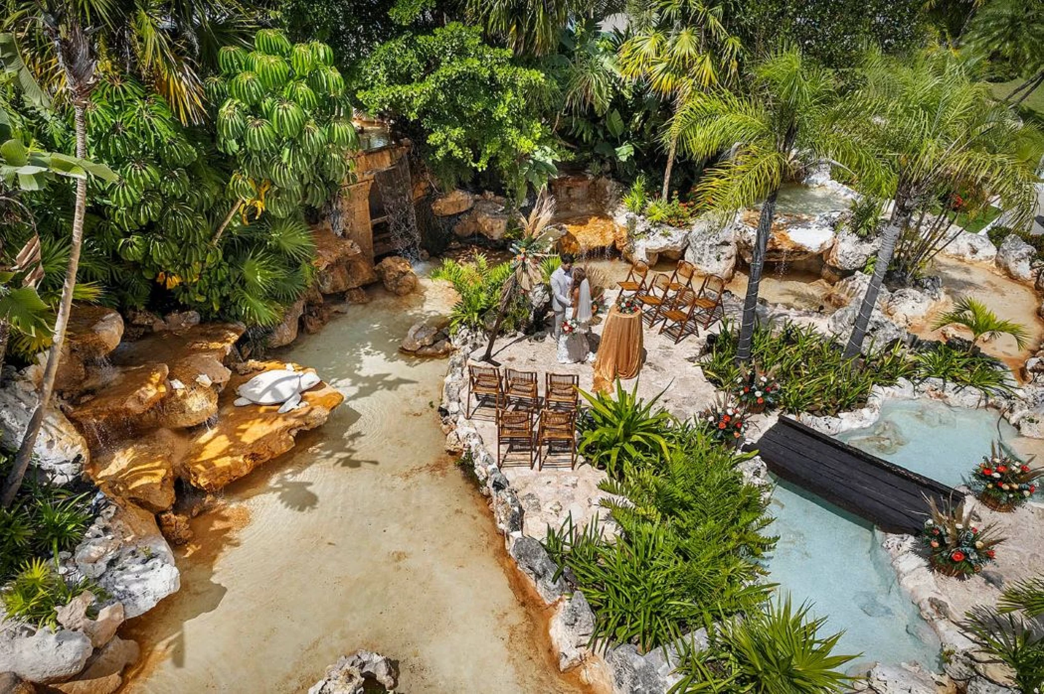 bride and groom at the waterfalls venue at Ocean Maya Royale