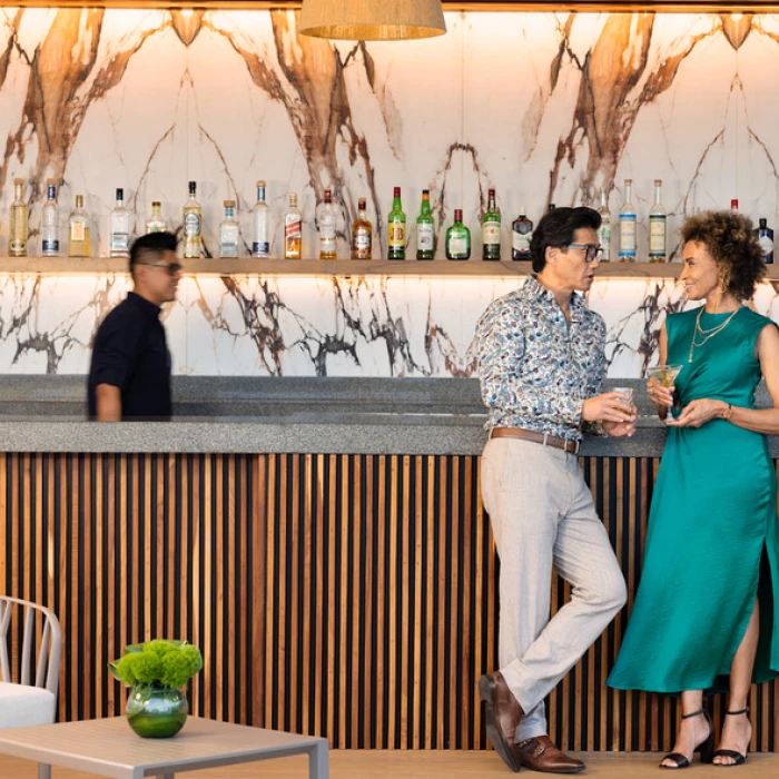 a couple at a bar at Hilton Cancun Mar Caribe