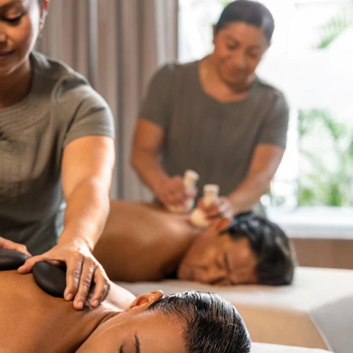 a couple getting a massage at the spa at Hilton Cancun Mar Caribe