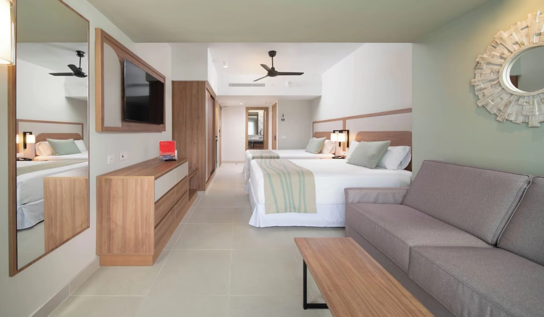 Furnished room with 2 beds and sofa at Hotel Riu Negril