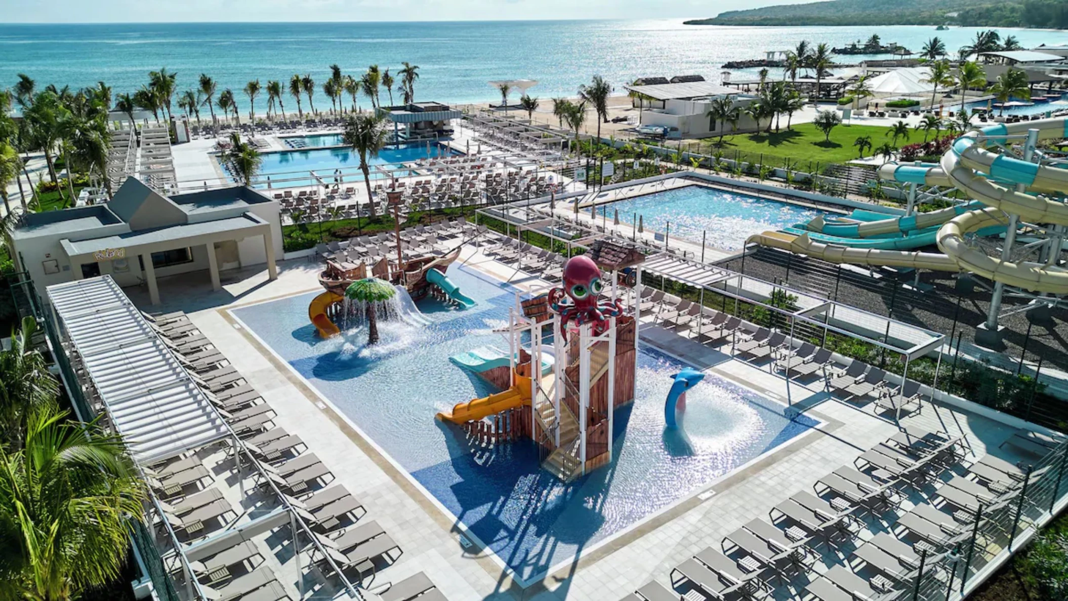 kids waterpark with the main waterpark in the background at Riu Palace Aquarelle Hotel