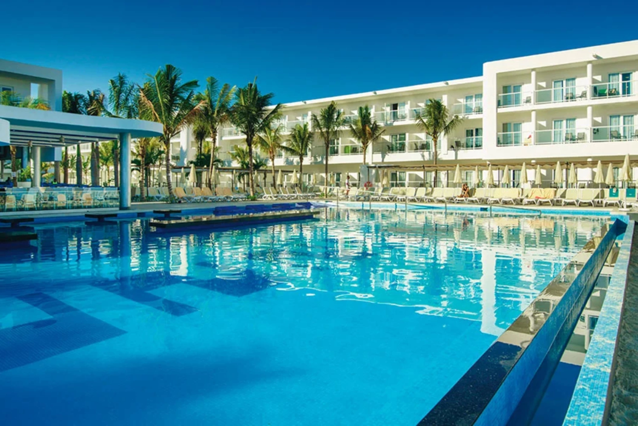 pool and resort building at Hotel Riu Reggae
