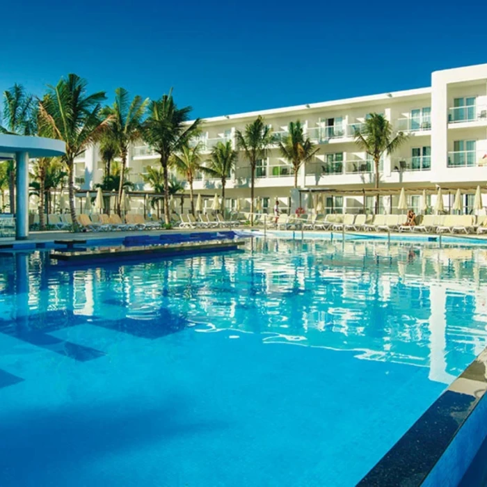 pool and resort building at Hotel Riu Reggae