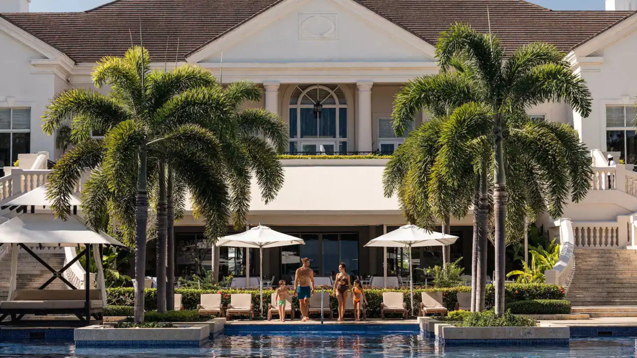 a family at the pool at Hyatt Ziva Rose Hall