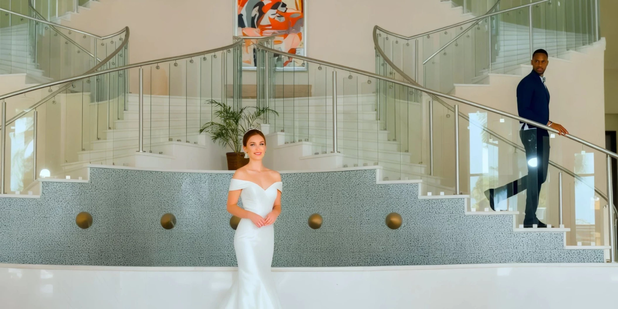 Bride and groom at the lobby staircase venue Iberostar Selection Rose Hall Suites