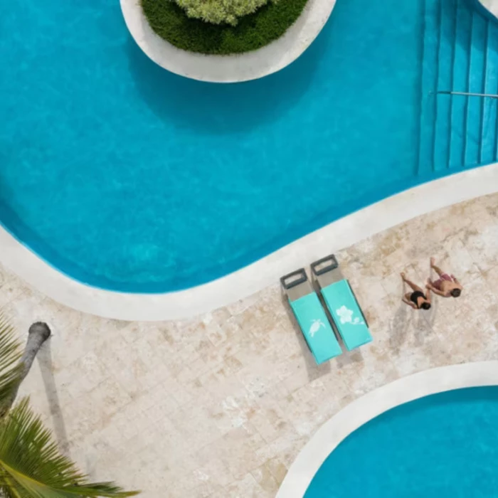 couple by the pool at Iberostar Waves Dominicana