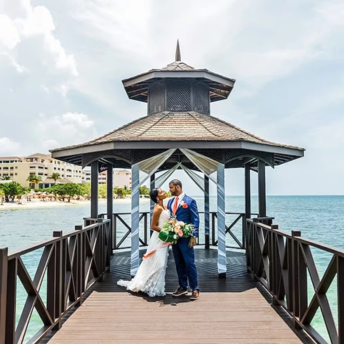 bride and groom at the pier gazebo venue at Iberostar Waves Rose Hall Beach