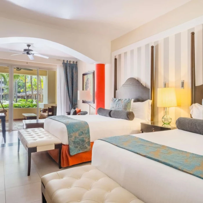 family room with two beds at JOIA Rose Hall by Iberostar