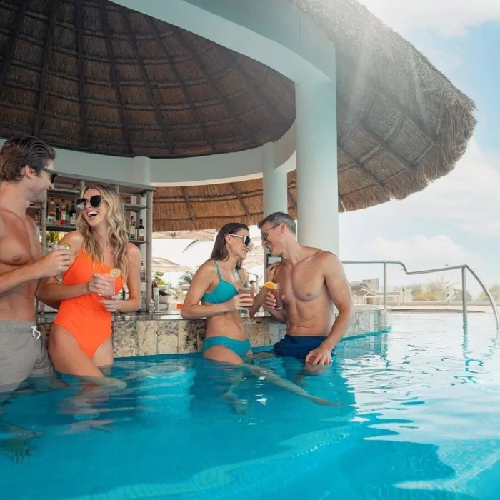 couples at the swim up bar at Le Blanc Spa Resort Cancun