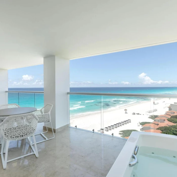 jacuzzi in the balcony of a suite overlooking the sea at Le Blanc Spa Resort Cancun