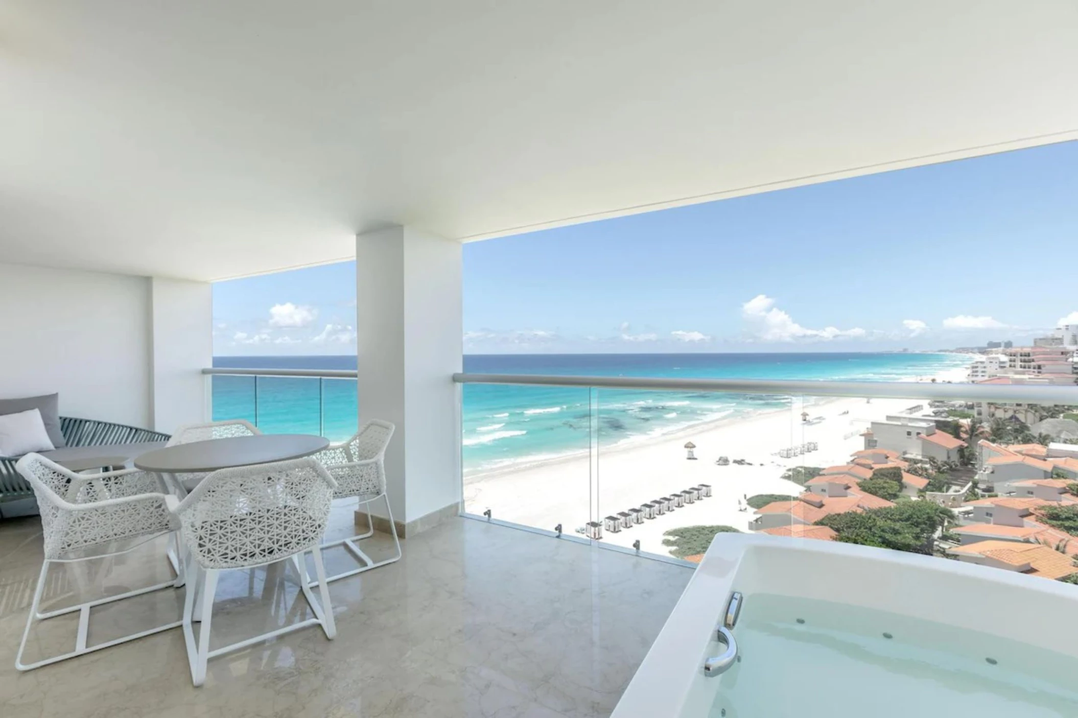 jacuzzi in the balcony of a suite overlooking the sea at Le Blanc Spa Resort Cancun