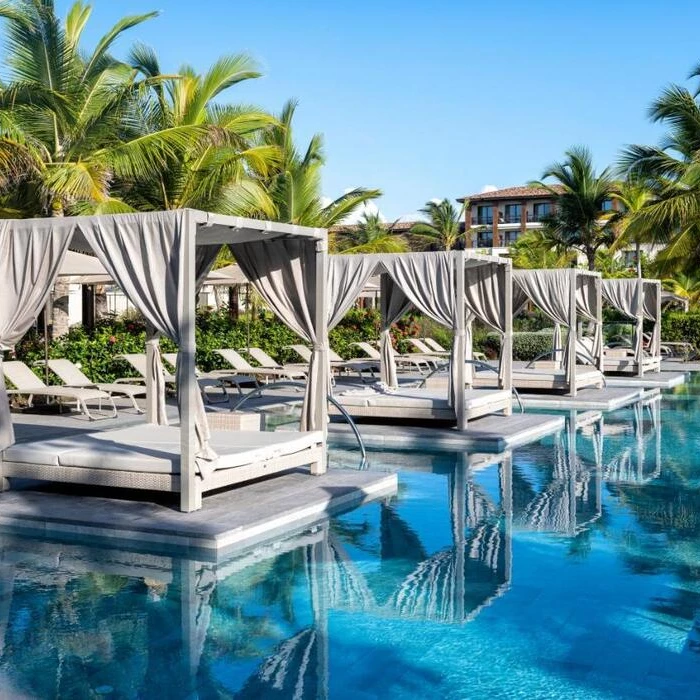 pool with loungers and cabanas at Lopesan Costa Bavaro Resort