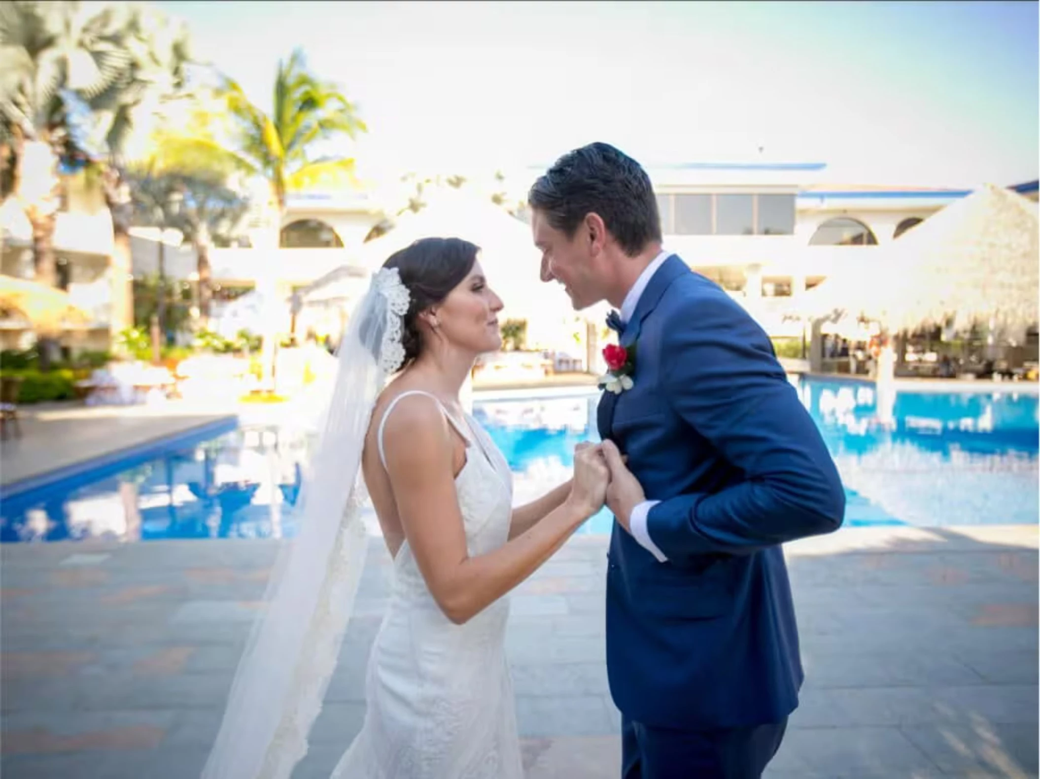bride and groom by the pool at Margaritaville Beach Resort Playa Flamingo