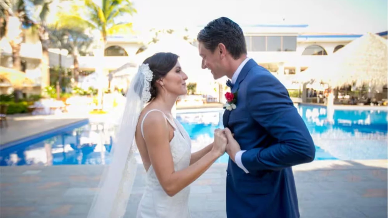 bride and groom by the pool at Margaritaville Beach Resort Playa Flamingo