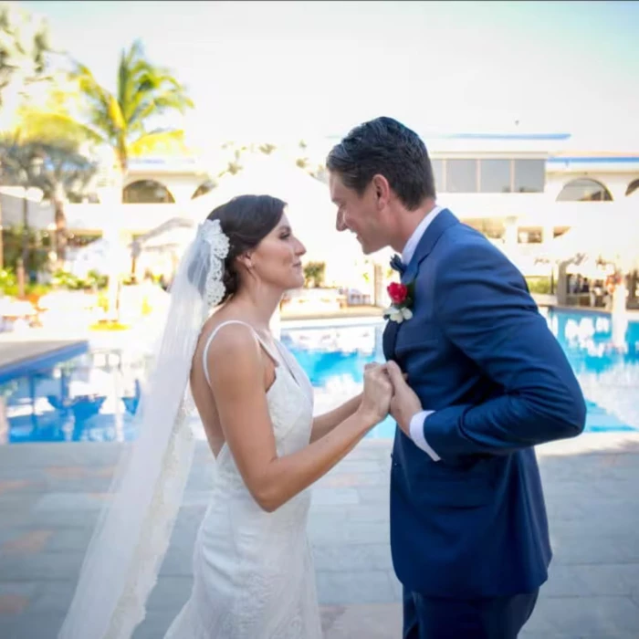 bride and groom by the pool at Margaritaville Beach Resort Playa Flamingo