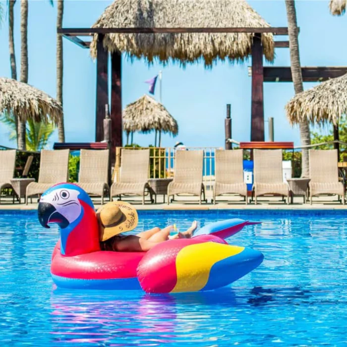 person in a pool float lounging the the pool at Margaritaville Beach Resort Playa Flamingo