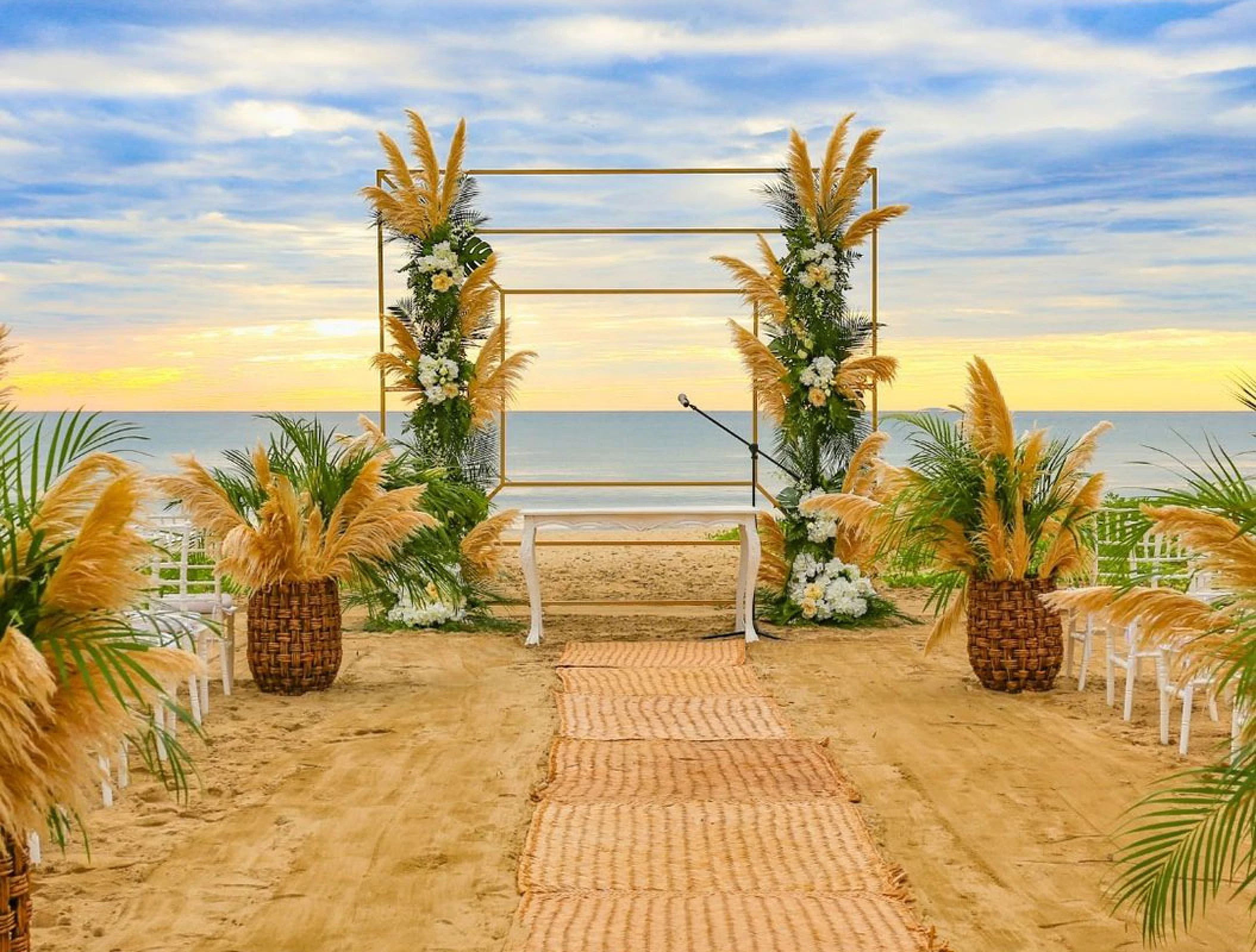 Beach ceremony decor on the beach at Marival Distinct Luxury residences.