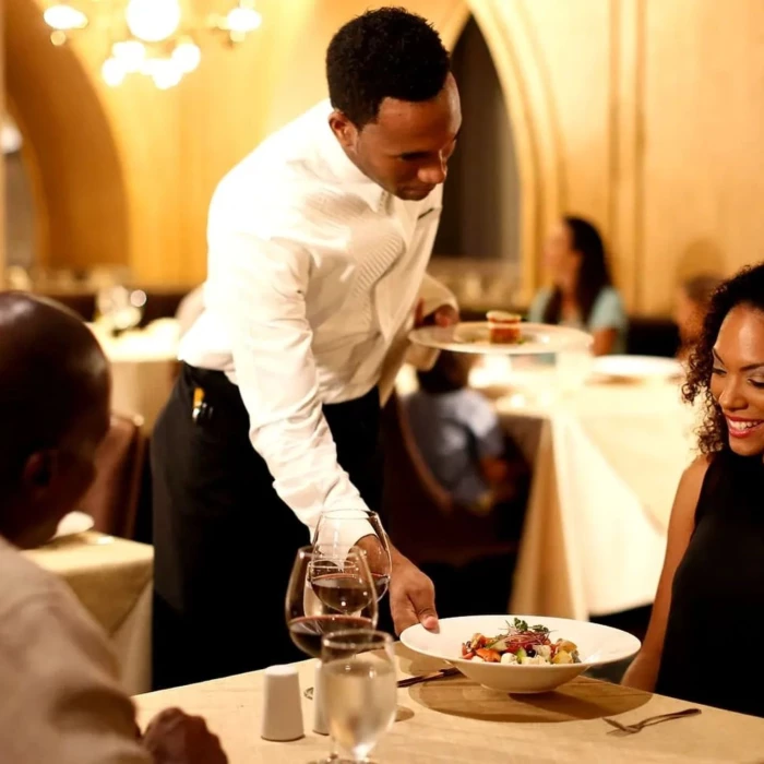 couple being served at a restaurant at Moon Palace Jamaica