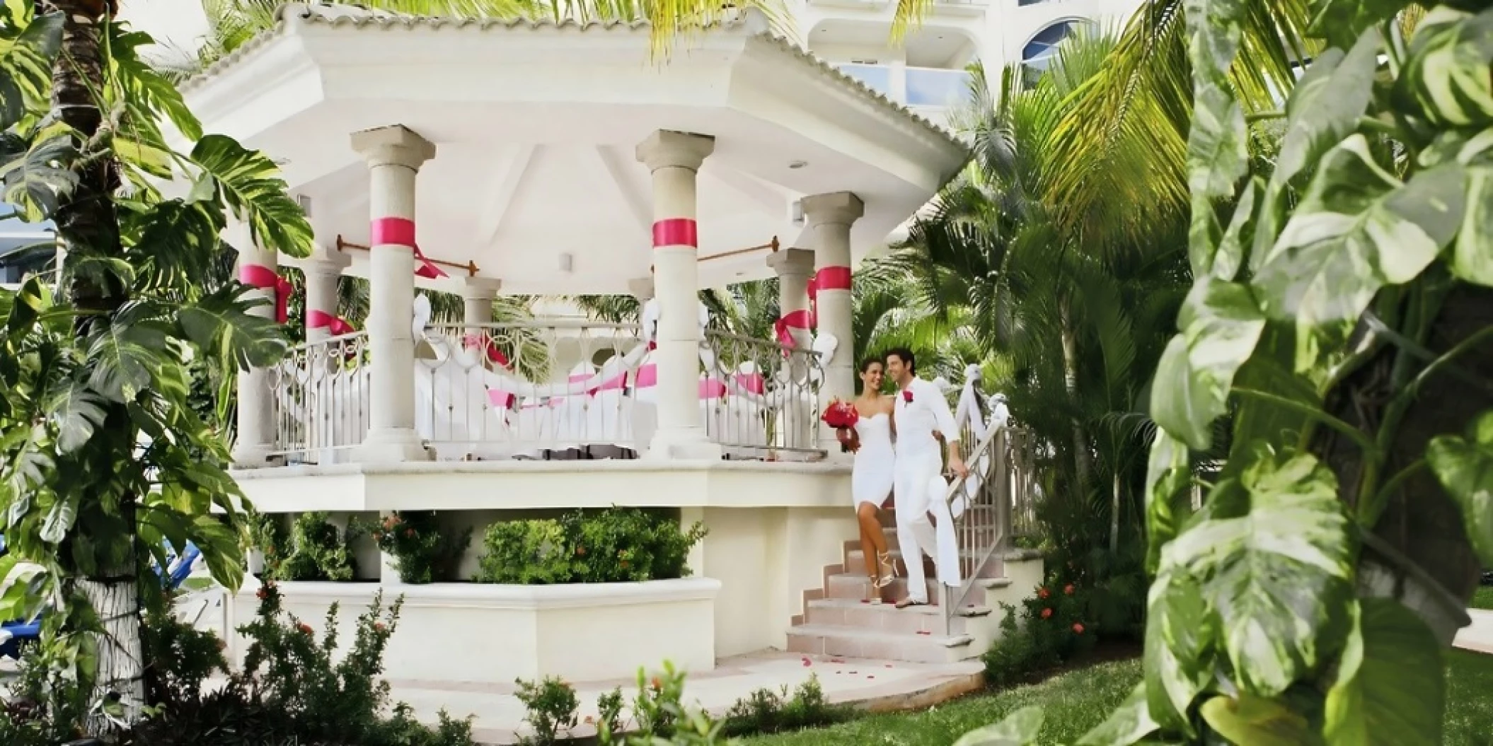 bride and groom at garden gazebo venue at occidental costa cancun