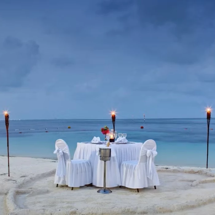 romantic dinner setup on the beach at Occidental Costa Cancun