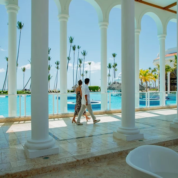 couple waling by the pool at Paradisus Palma Real