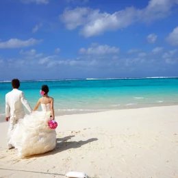 bride and groom on the beach holding hands
