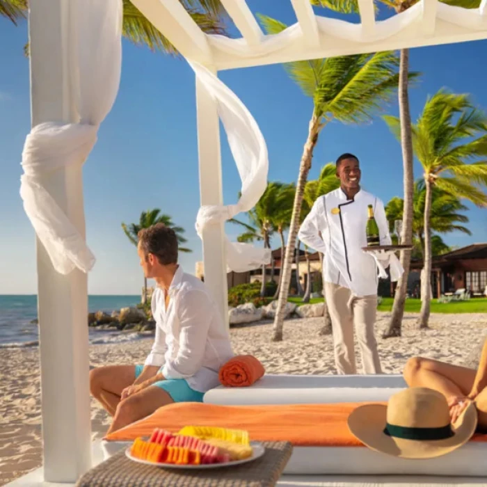 couple enjoying beachside service at Sanctuary Cap Cana