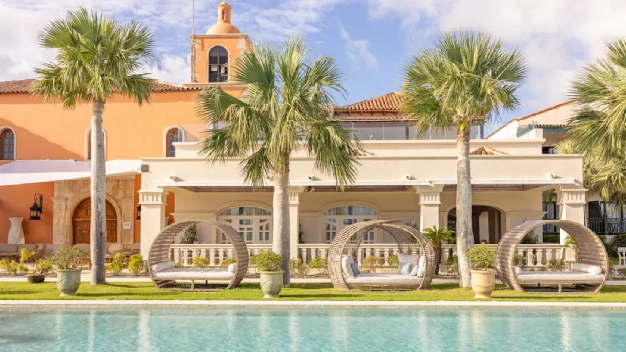 pool and cabanas and resort building at Sanctuary Cap Cana