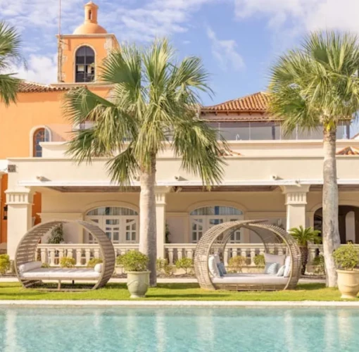 pool and cabanas and resort building at Sanctuary Cap Cana